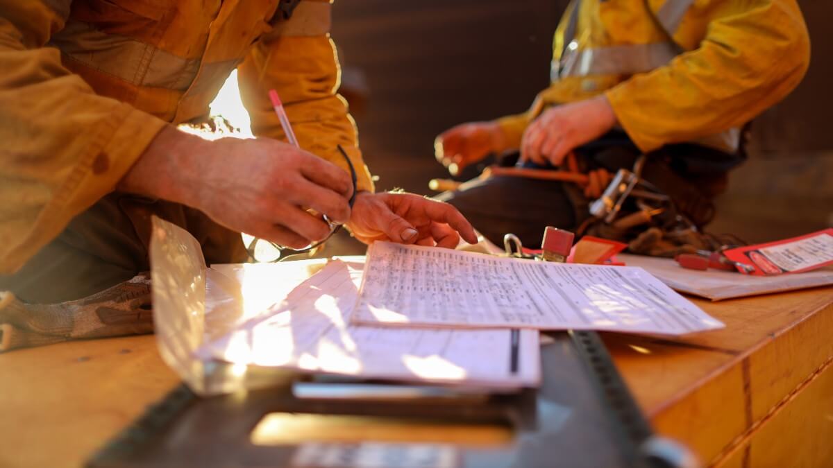 builders working on checking regulations