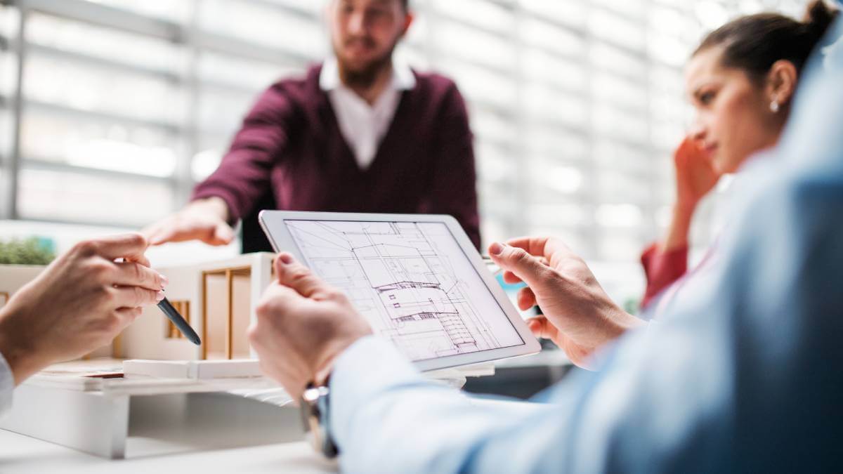 Group Project Meeting Looking At A Drawing On A Screen