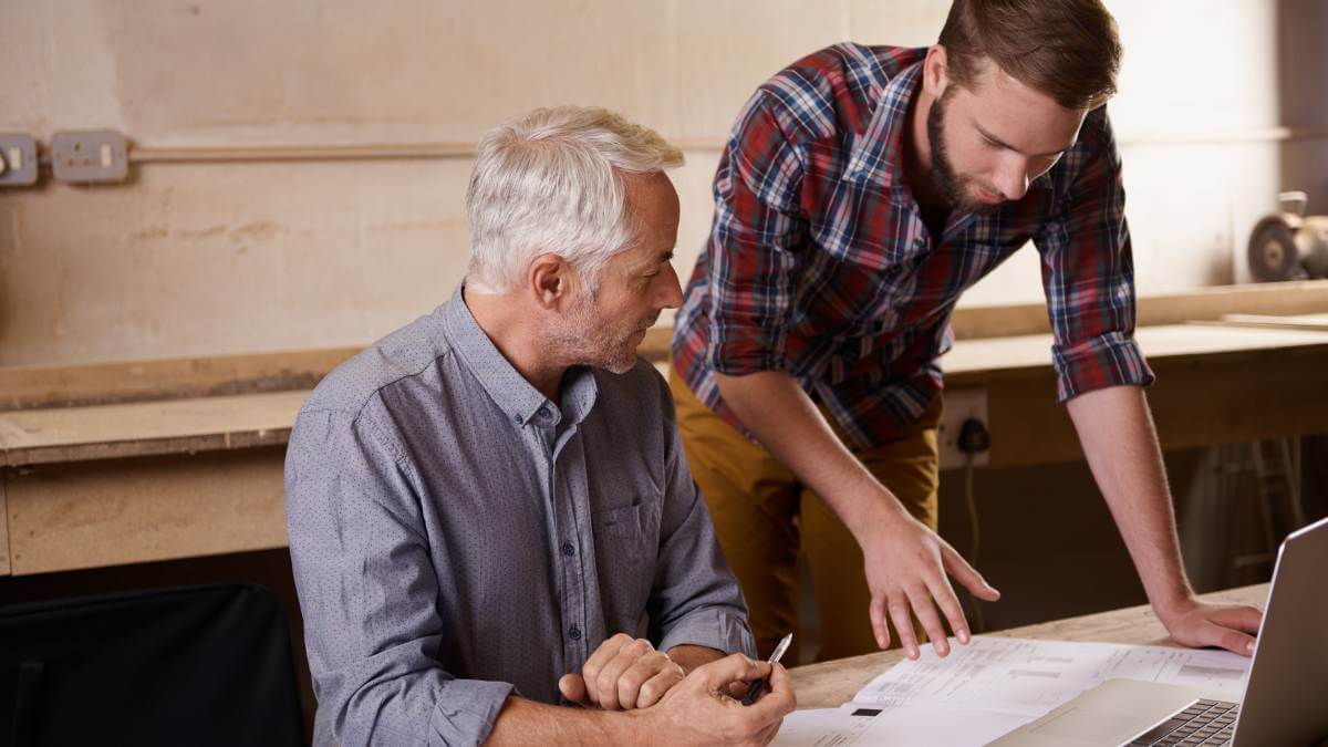 two men checking over papers
