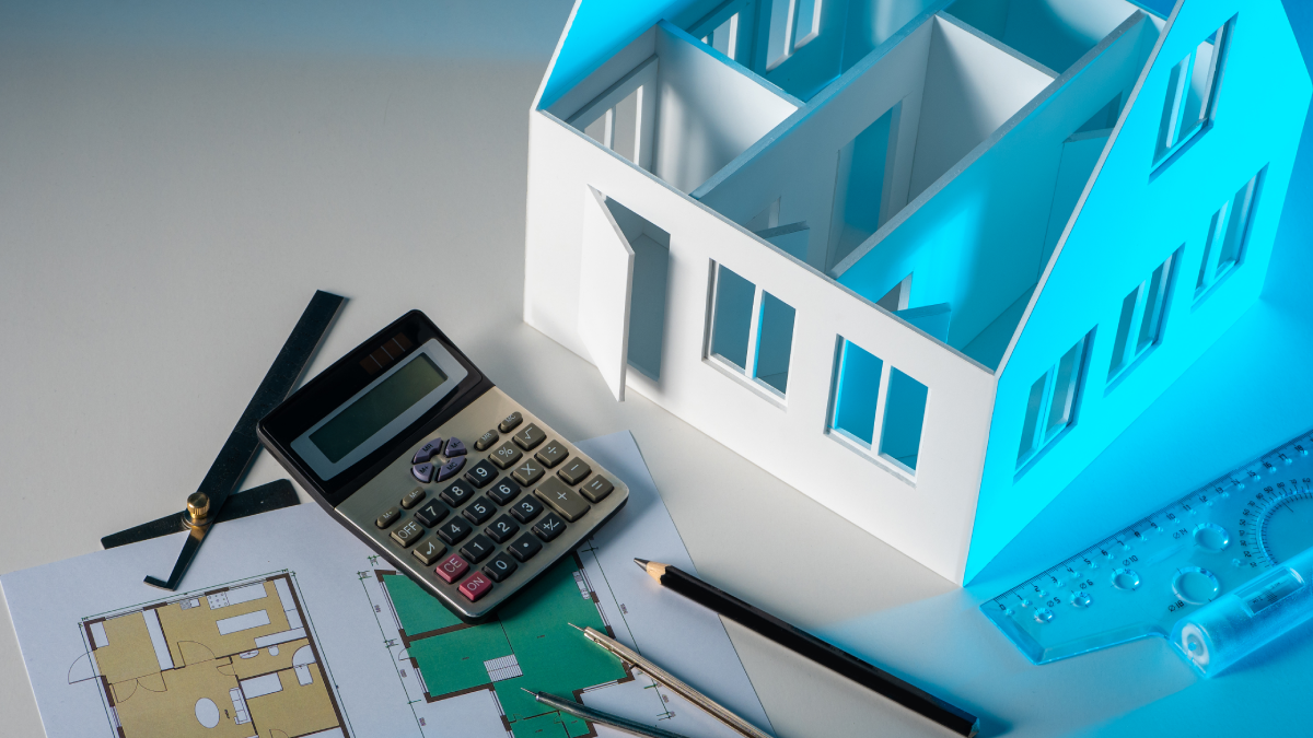 3D house with calculator on a tabl